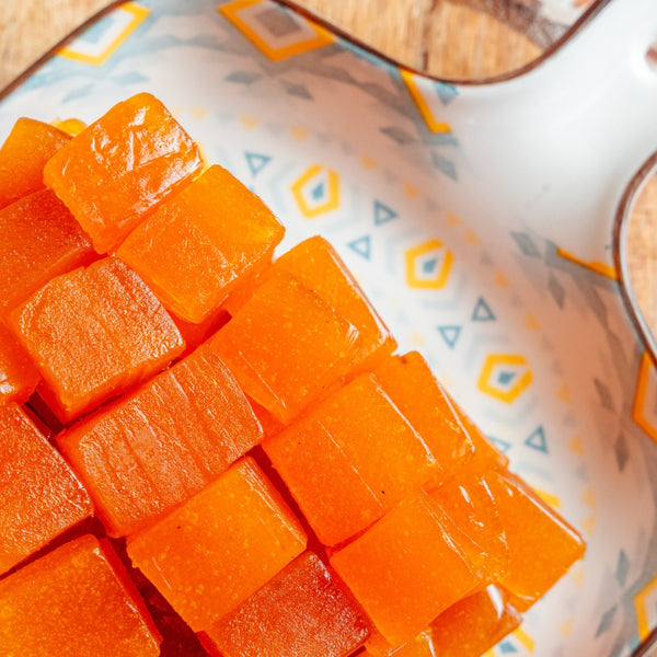 Cubes of aampapad on a decorative plate with a geometric pattern