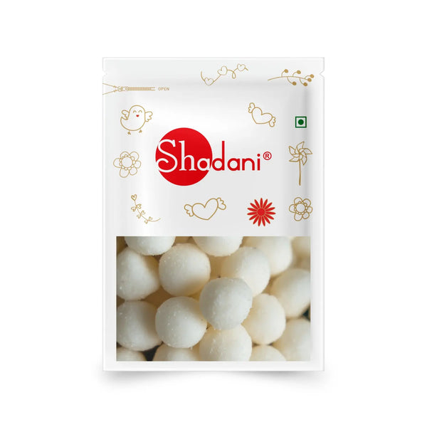 A package of Shadani Chikankari Parathas, featuring a white bag decorated with gold doodles and a prominent red circular logo with white text. The lower half of the packaging displays a close-up photo of the white, round parathas inside.