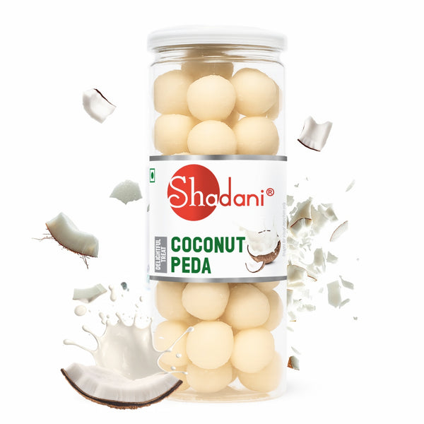 Jar of Shadani Coconut Peda with coconut pieces and milk splashes on a white background