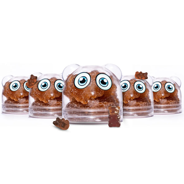 Five clear plastic shadani dome-shaped containers holding brown gummy bear-shaped candies, arranged in a row on a white background. The front center dome is larger and shows a small brown gummy bear placed outside the dome in front.