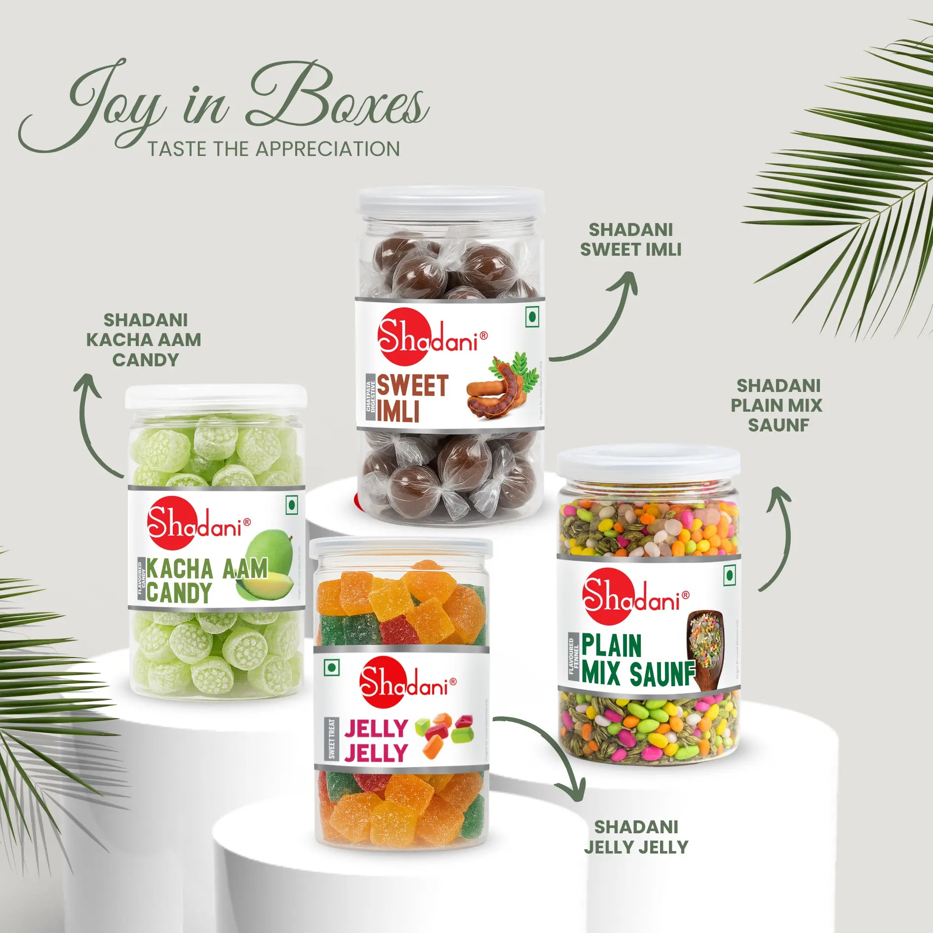Assorted Shadani candy packages on a white surface with green leaves. Corporate gift hamper products 