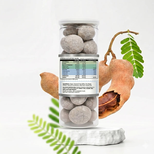 Can of tamarind balls with tamarind fruit and leaves on a white background