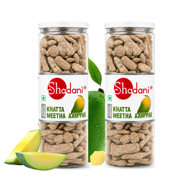 Two clear plastic cans of Shodani Khatta Meetha Aam-Pak (mango pickle) on a white background, styled with fresh mango slices and a whole mango.