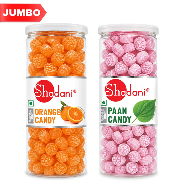 Two clear plastic jars of Shadani flavored candy on a white background, one labeled Orange Candy with orange round candies inside, and the other labeled Paan Candy with pink round candies inside. A red 'JUMBO' banner appears in the top left corner.
