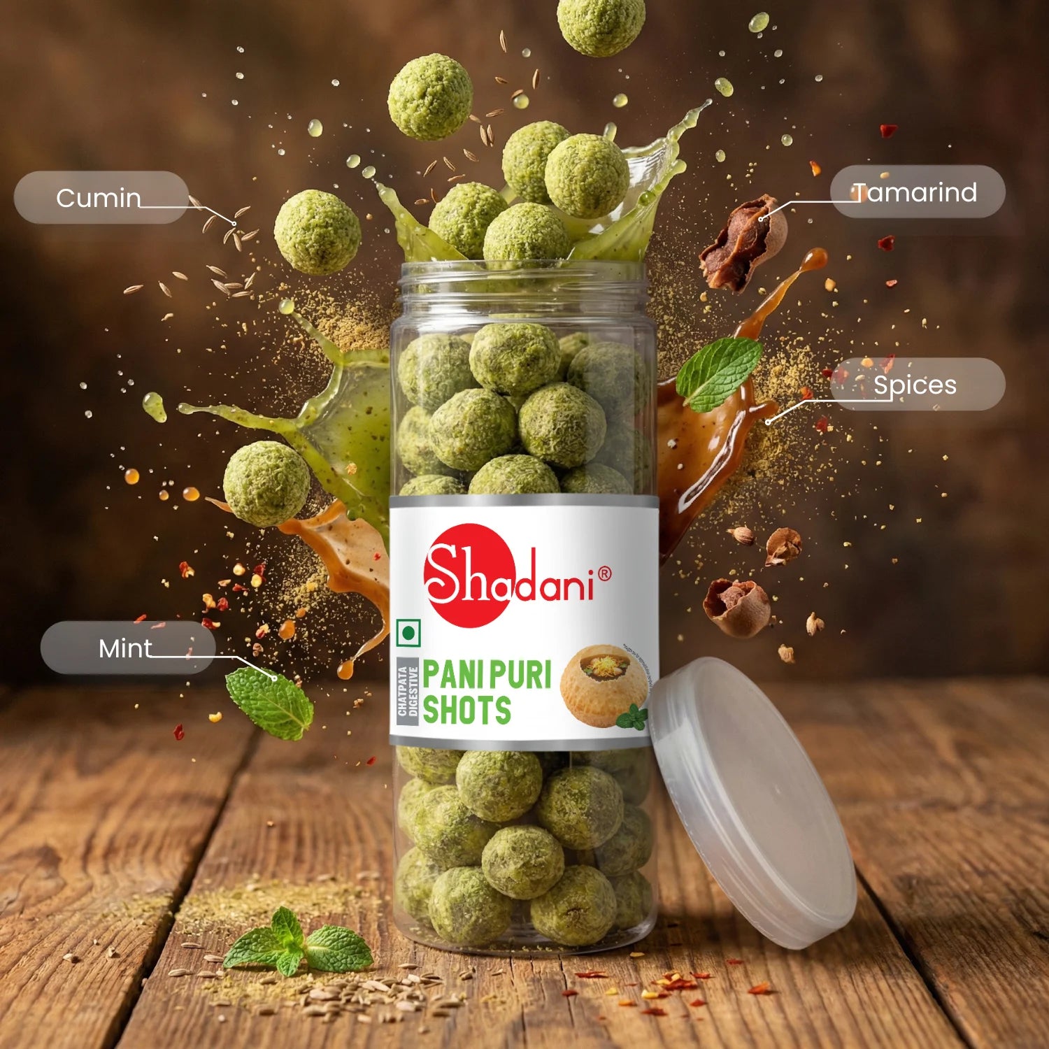 Shadani Pani Puri Shots with ingredients like cumin, tamarind, spices, and mint on a wooden background