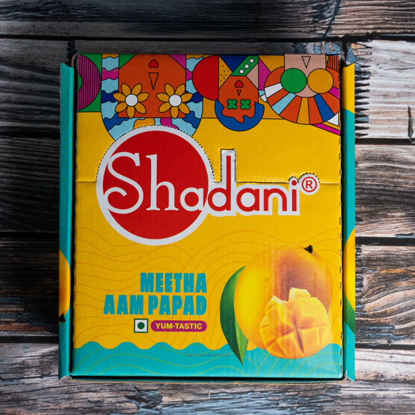 Shadani Meetha Aam Papad packaging on a wooden surface