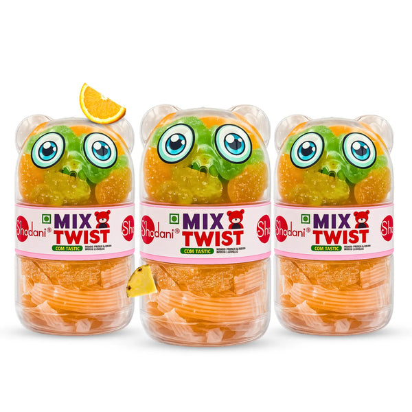Three Shadani Mix Twist gummy bear jars arranged side by side on a white background, with orange gummy bears visible through the clear jars and decorative citrus slices near the top.