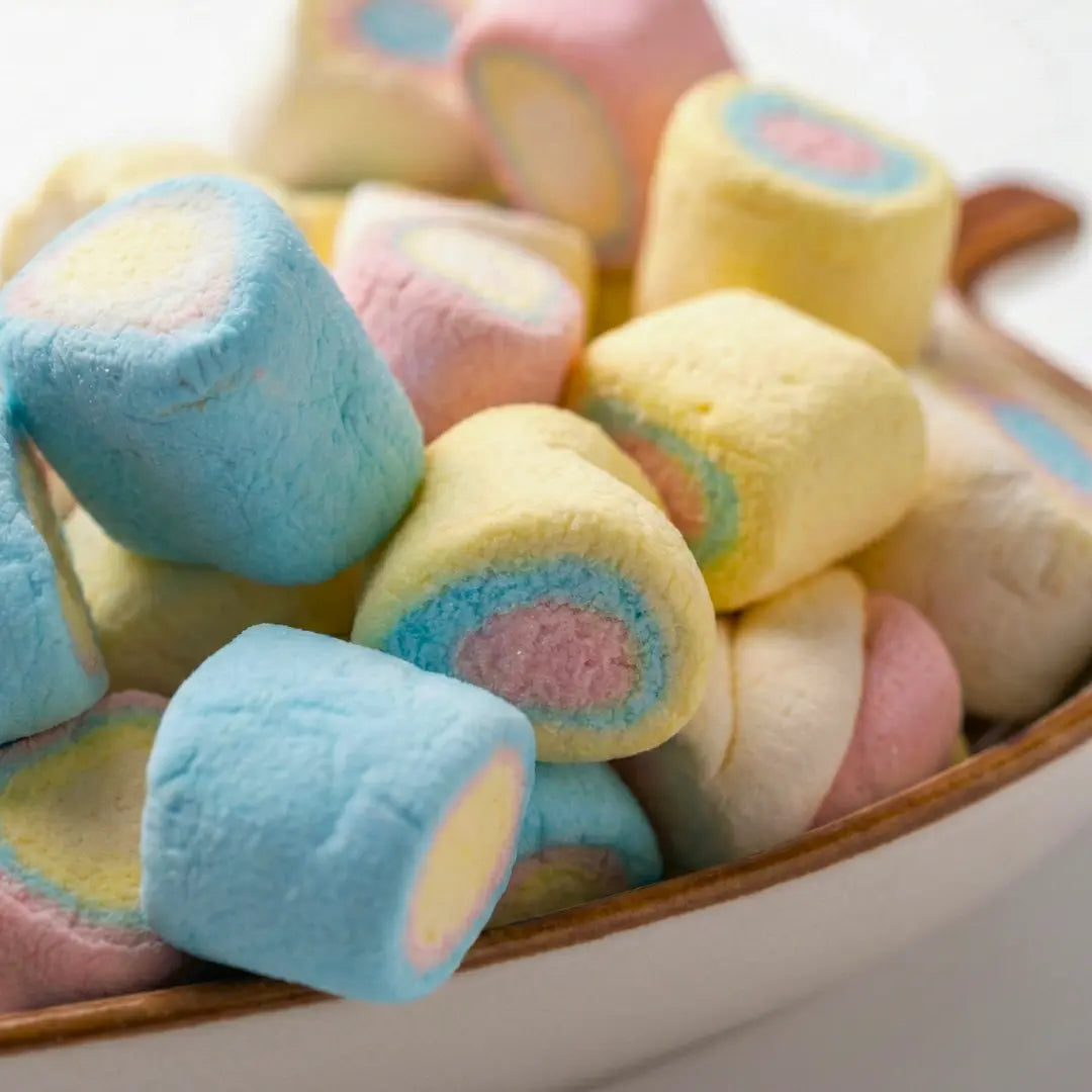 Pastel-colored marshmallows in a wooden bowl