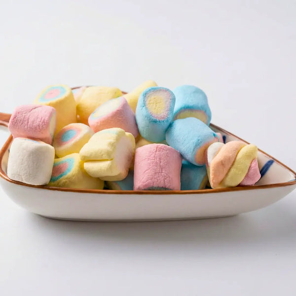 Colorful Shadani marshmallows in a bowl on a white background