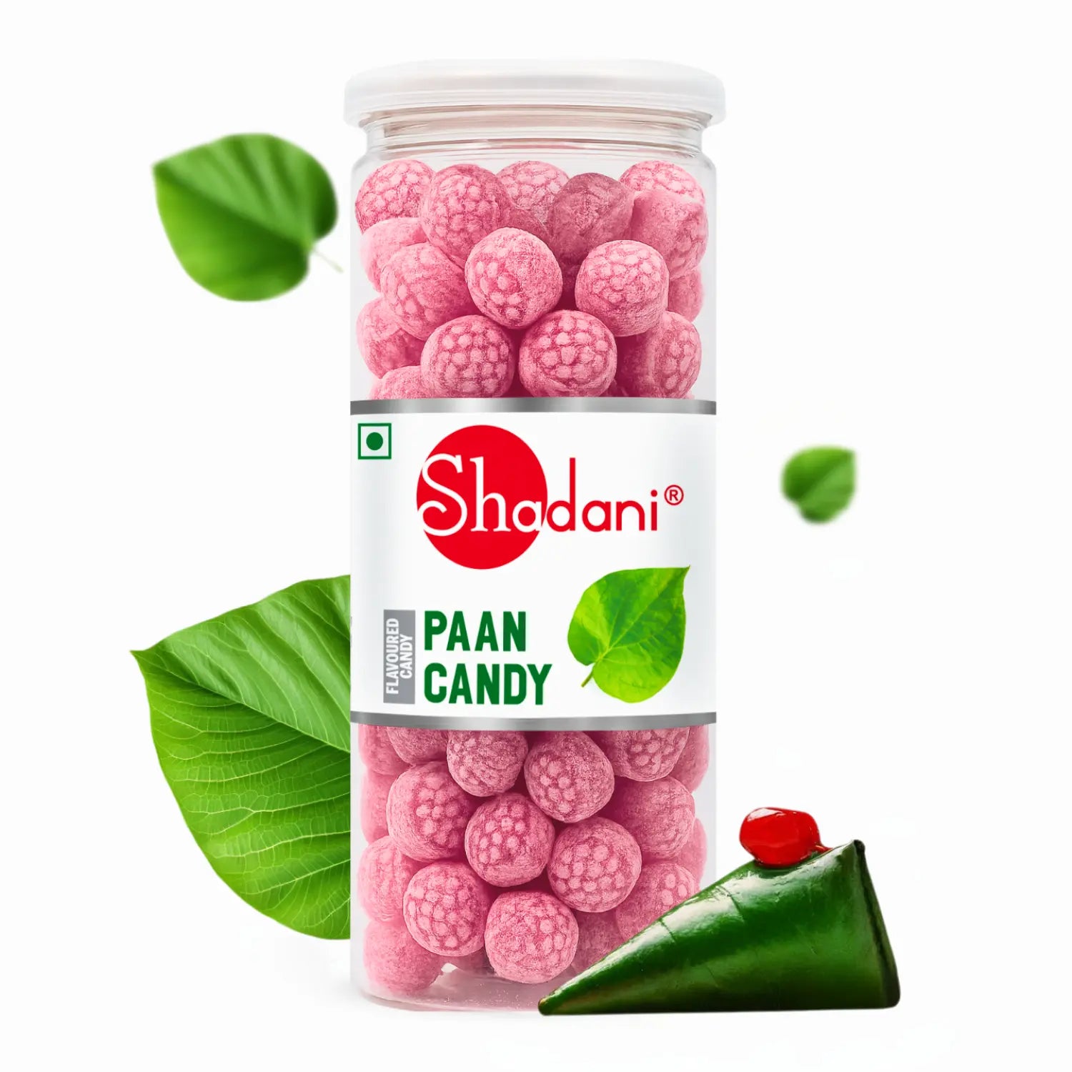 Jar of pink Shadani paan candy with green leaves and a piece of cake on a white background