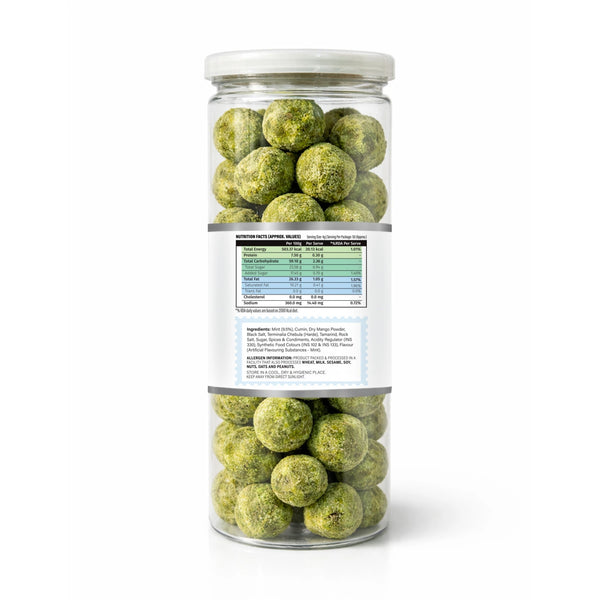 Jar of green spherical treats with a label on a white background