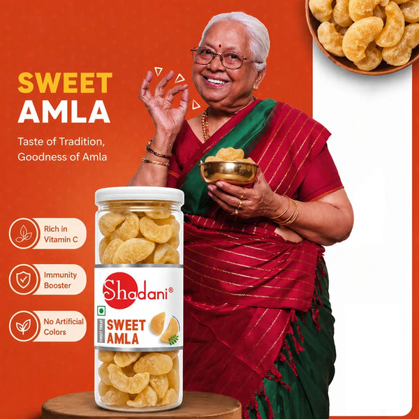 Woman holding a bowl of sweet amla with Shadani brand packaging on an orange background