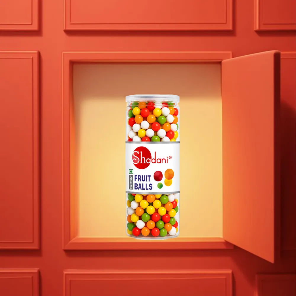 Shadani Fruit Balls container with colorful gumballs in a red cabinet.