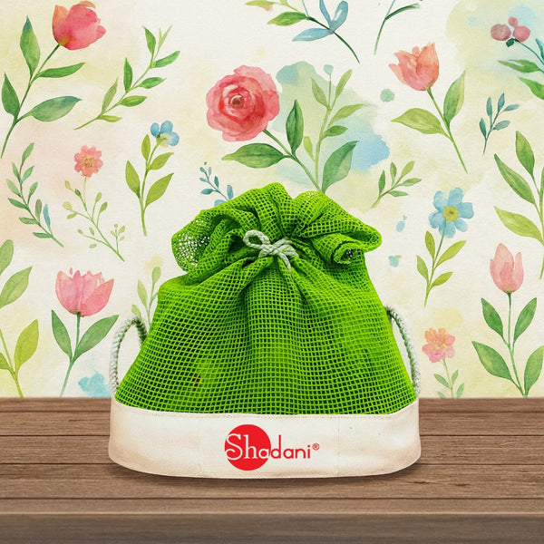 Green drawstring bag on a white stand with floral background logo shadani